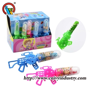 pistola forma mano sacudiendo juguete giratorio piruleta caramelo